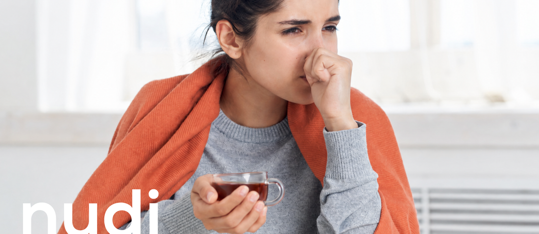 Woman wrapped in a jumper feeling cold during menopause