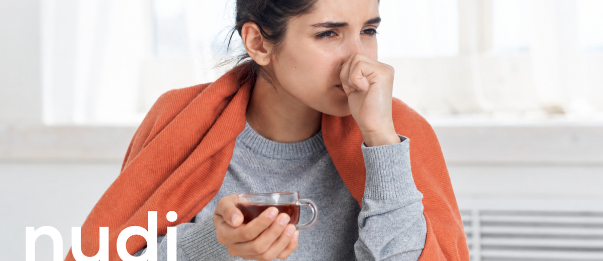 Woman wrapped in a jumper feeling cold during menopause