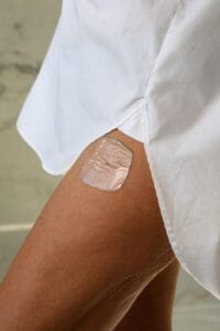 HRT patch on womans thigh